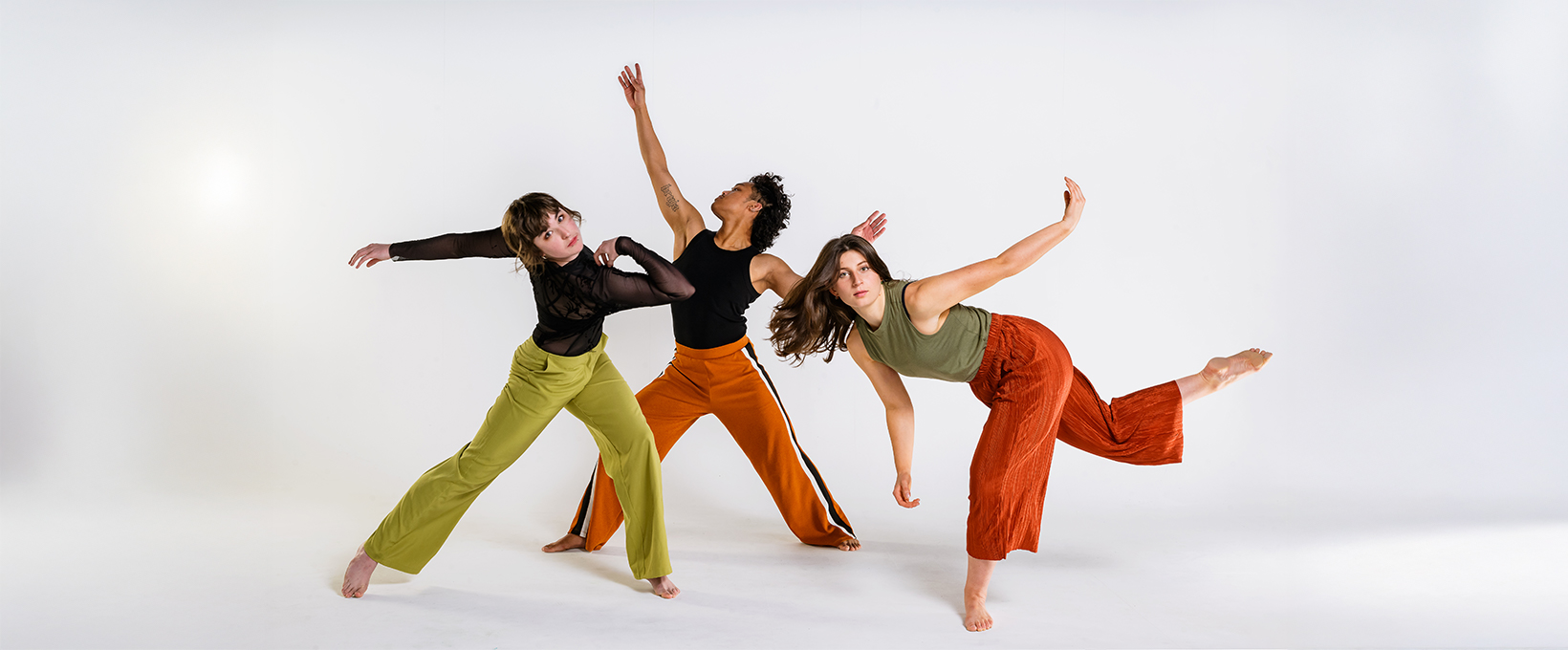 Group of three dance students pose