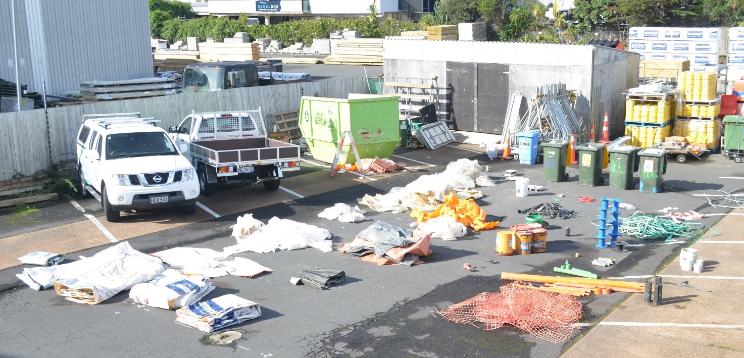 Building site plastic waste sorted in to piles in a carpark 