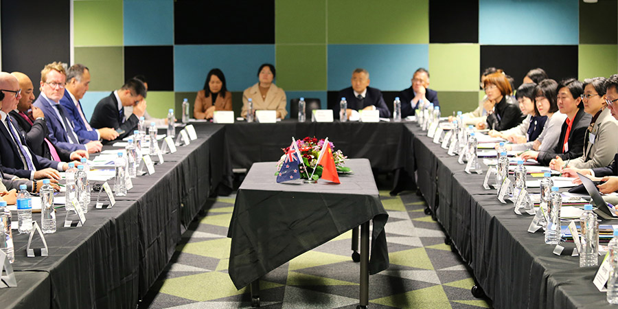 Delegation from China Education Association for International Exchange (CEAIE) meet with Unitec staff around large tables set out in a u formation