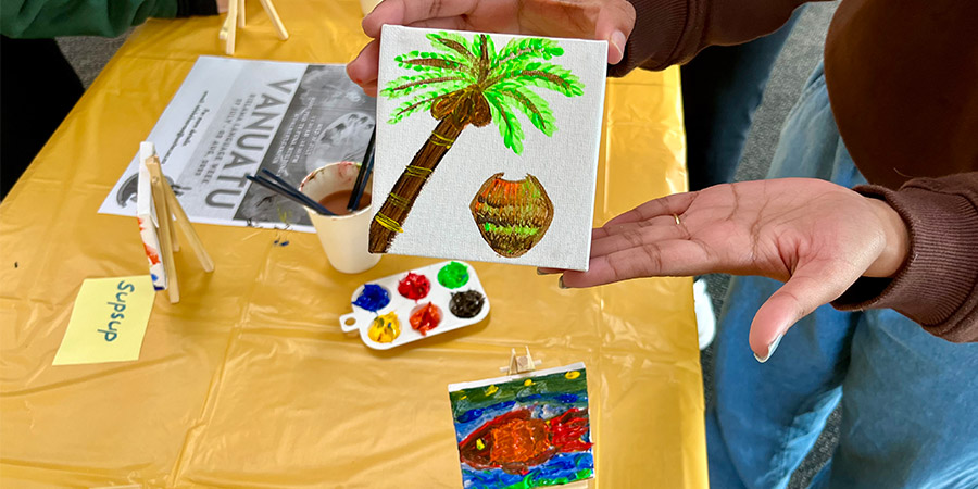 Studnet holds small paiting cretaed at let's celebrate Vanuatu Bislama Language Week workshop