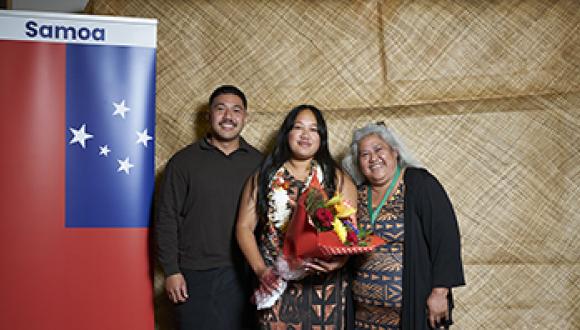 Proud family celebrating Samoan graduate's graduation