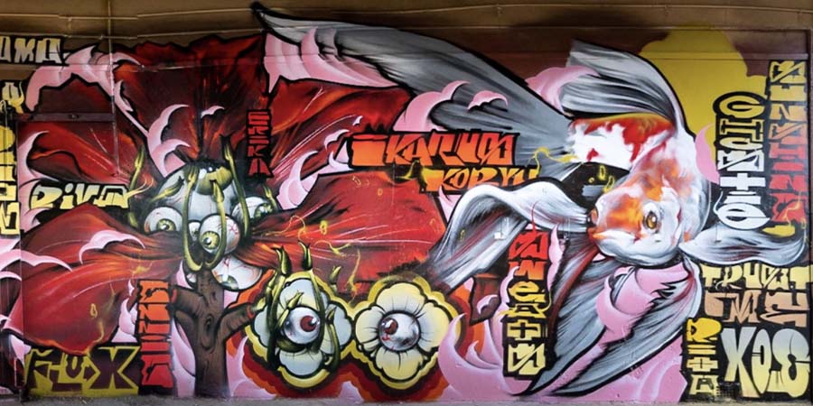 Bobby Hung AKA Berst graffiti mural featuring a fish with large, delicate fins and tail.