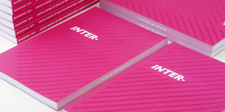 A pile of copies of 'Inter', the graduate catalogue.