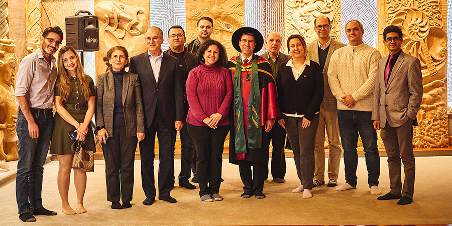 Professor Hamid Sharifzadeh, along with colleagues and loved ones, with their shoes off in the Unitec Marae.