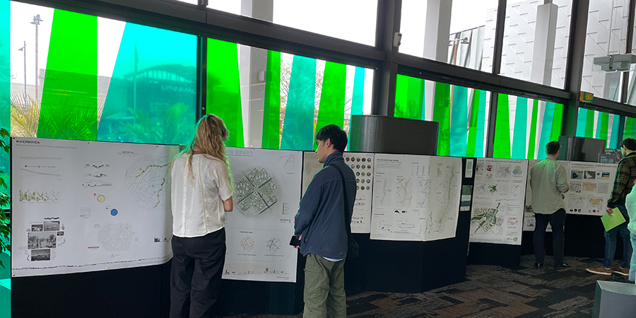 A wall of landscape Architecture designs displayed in the New Lynn War Memorial Library