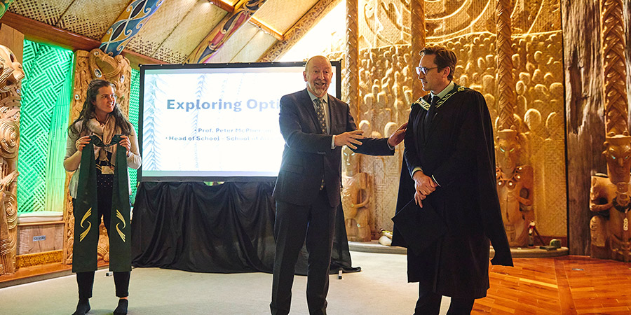 Martin Carroll presents the stole to Peter McPherson