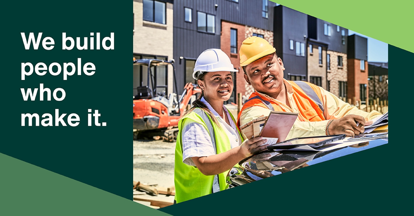 Construction campaign banner - two workers review plans at a building site