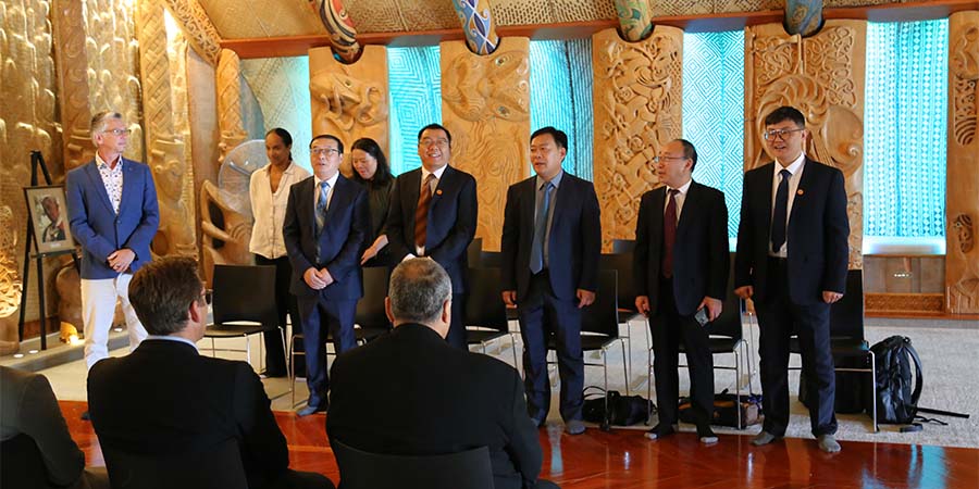 The Chinese delegation stand at the welcoming pōwhiri in Unitec's marae.