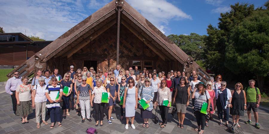 A group of career advisors outside the Te Noho Kotahitanga wharenui.