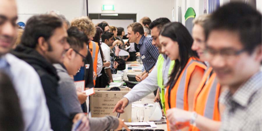 Visitors and staff chatting at a Unitec career expo.