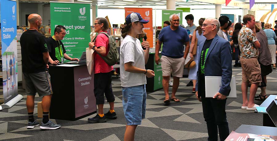 Attendees chat surrounded by booths at the Mt Albert Campus Info and Enrolment Day.
