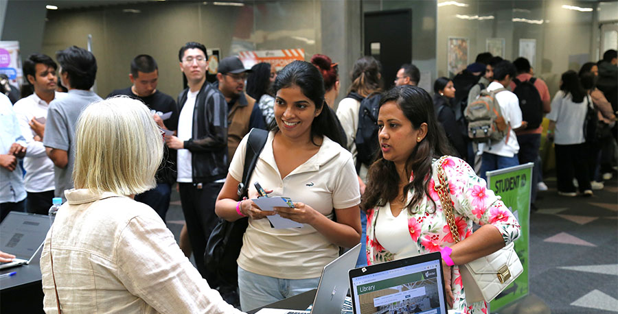 Students chat during international orientation.