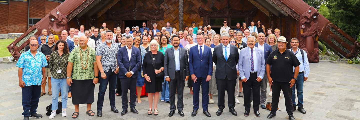 MIT and Unitec council pose with staff in front of Ngākau Māhaki at Unitec Te Noho Kotahitanga marae
