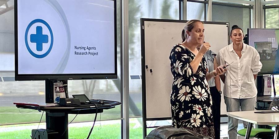 Attendees at the AI Agent event listen to a speaker.