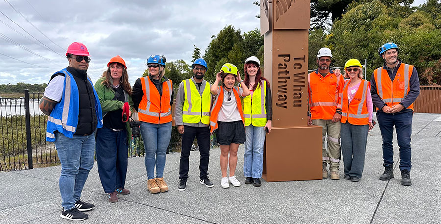 Kaimahi and ākonga pose with the installed sculptural marker.