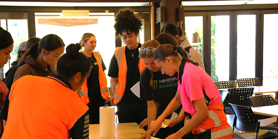 A group of women help themselves to a morning tea.