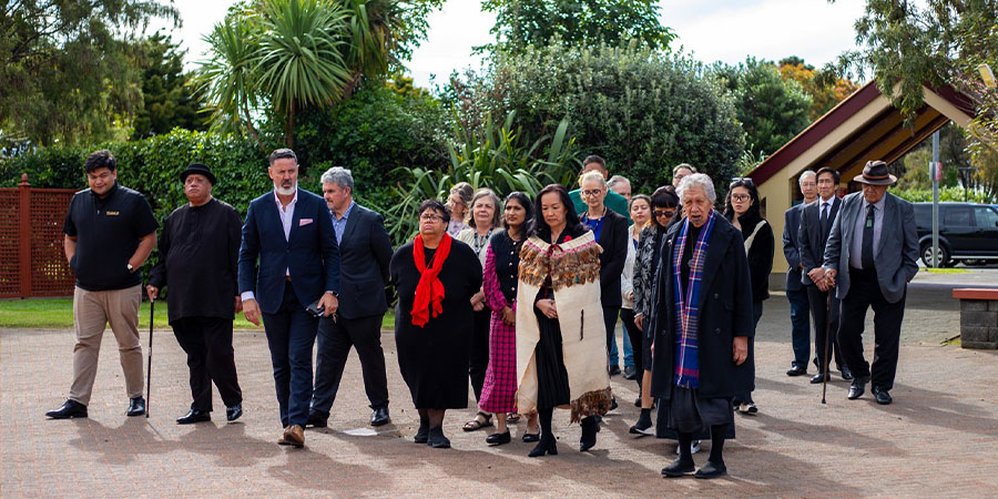 Attendees walk onto the marae.