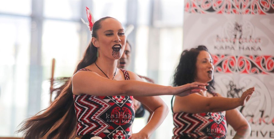 Two wahine Māori in a kapa haka performance.