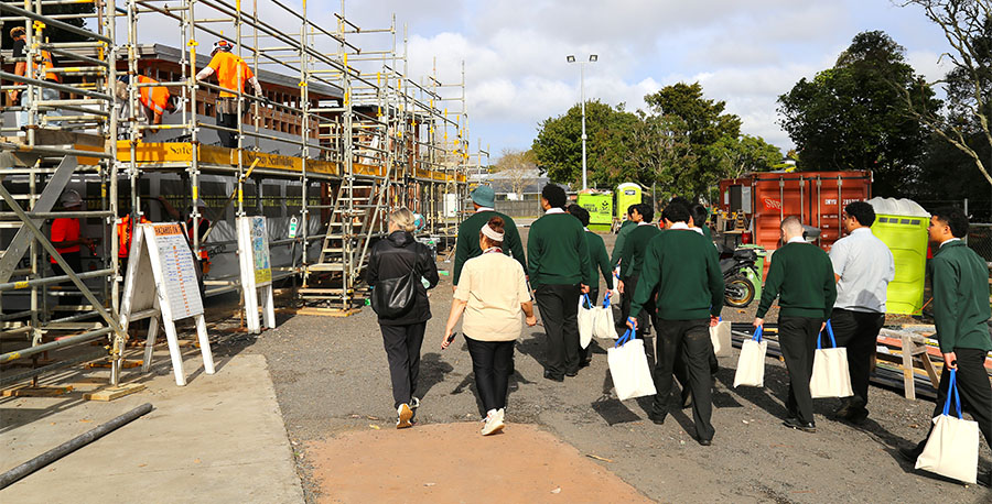 A group of students walk next to the Trades building site on Mt Albert Campus.