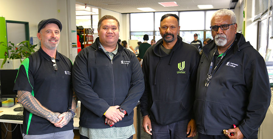 Four trades lecturers smile for the camera.