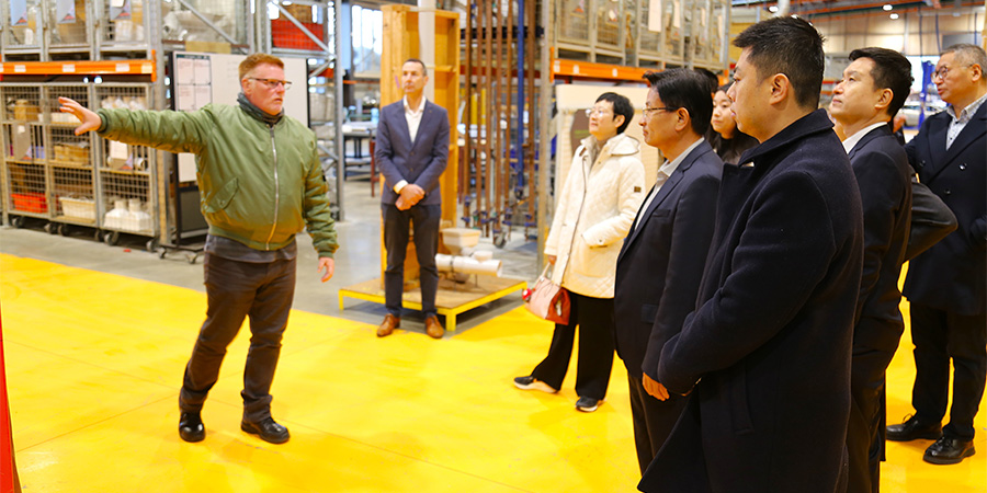 Delegates listen to a lecturer during a tour of the Mataaho trades facility. 