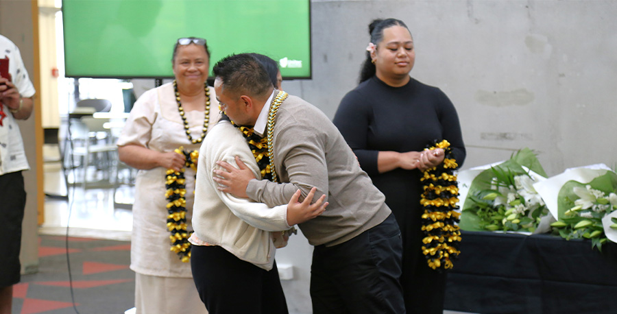 A student receives their scholarship award.