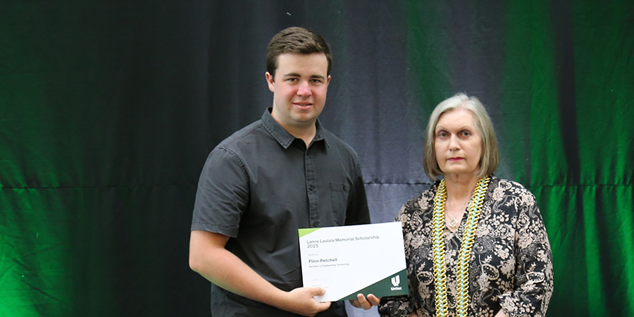 A student receives their scholarship award.