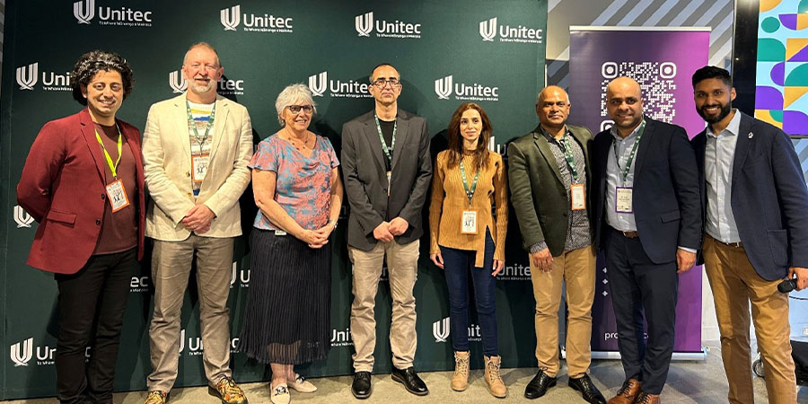 A group of Unitec staff smile for the camera.