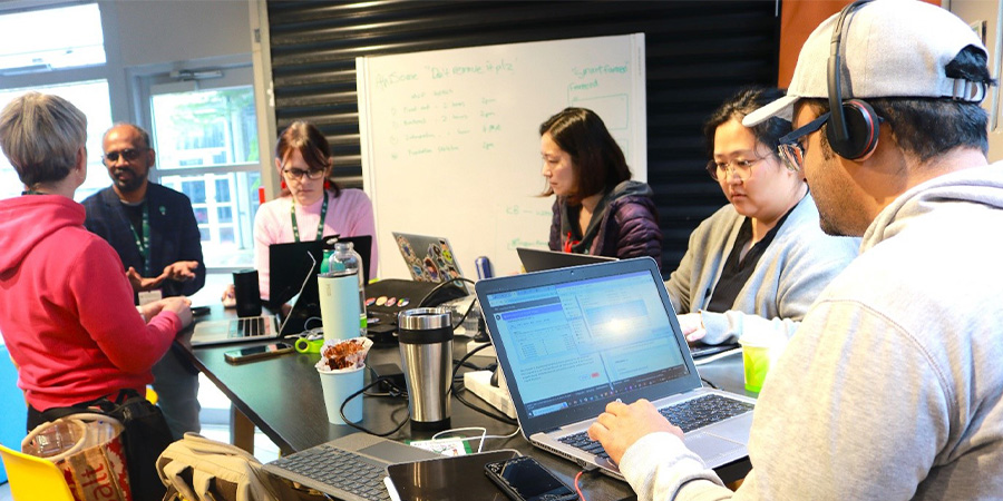 Students hard at work during an AI hackathon.