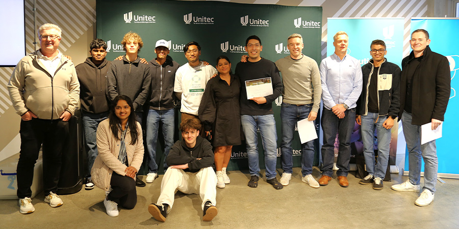 The winning team of the hackathon pose with the judges holding their certificates.