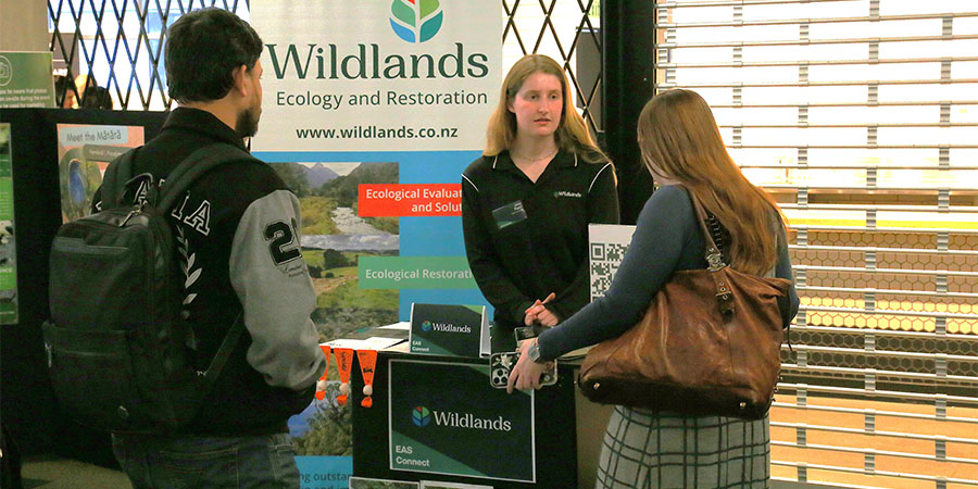 Students talk to an employer at their stand at the event. 