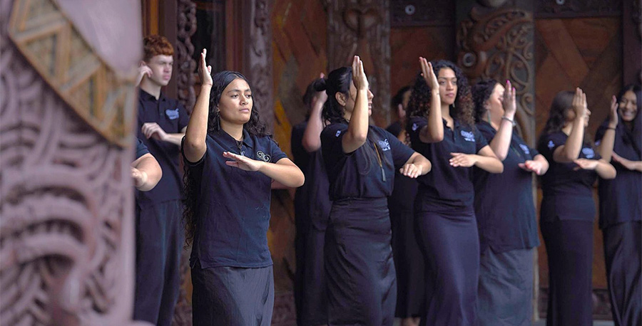 A group perform a dance outside the wharenui at Te Noho Kotahitanga Marae.