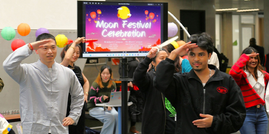 Staff and students have a go at a traditional dance.