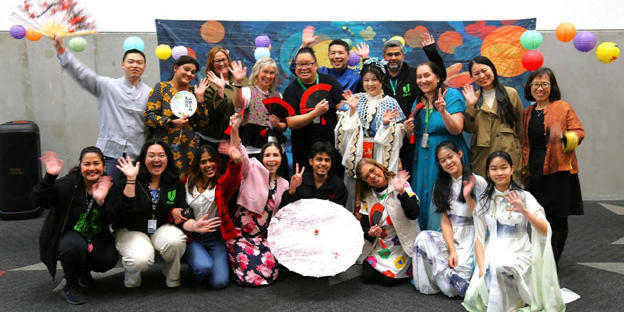 Staff and performers from the Moon Festival pose for a group photo.