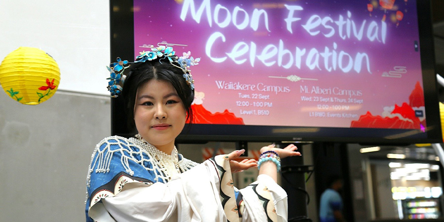 Yifei Cheng in traditional Chinese attire poses for a photo.
