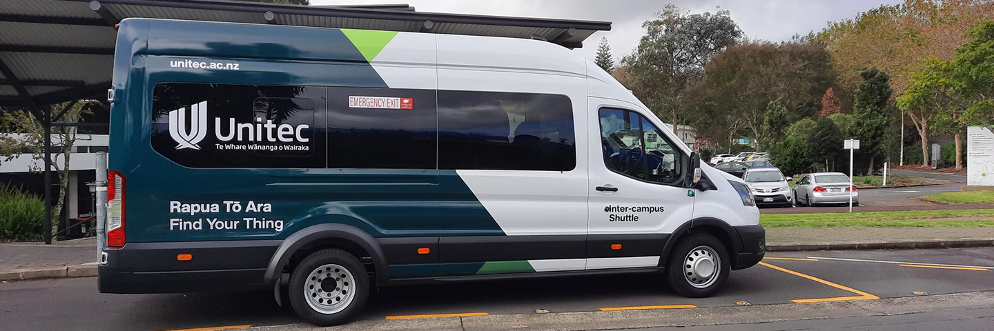 Unitec inter-campus shuttle bus viewed from the side when it is parked at the Mt Albert campus shuttle stop