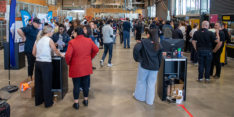 Students talk to companies at different booths during the event.